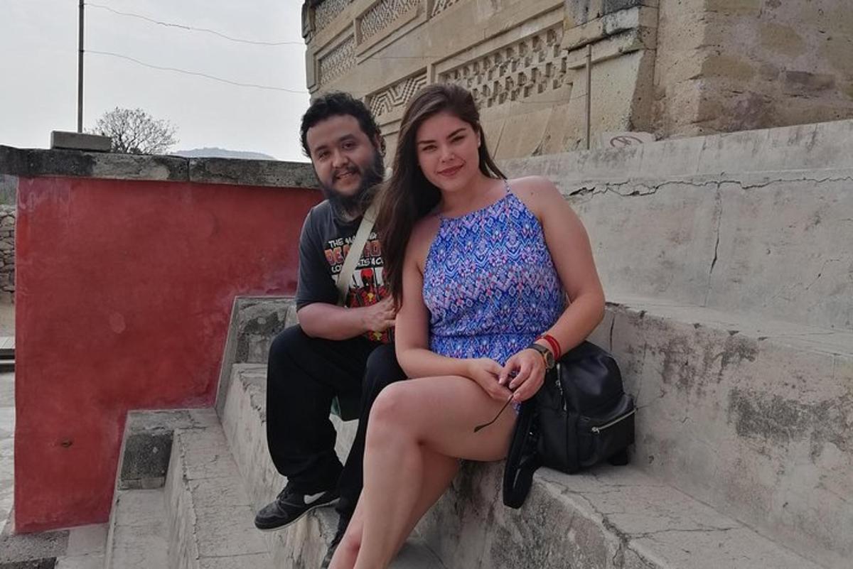 a man and a woman sitting on some steps