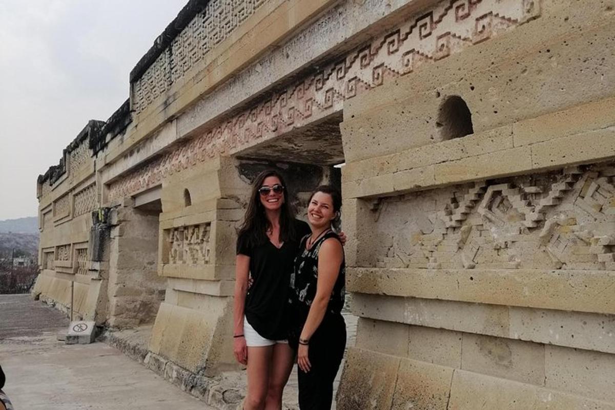 two women standing in front of a building