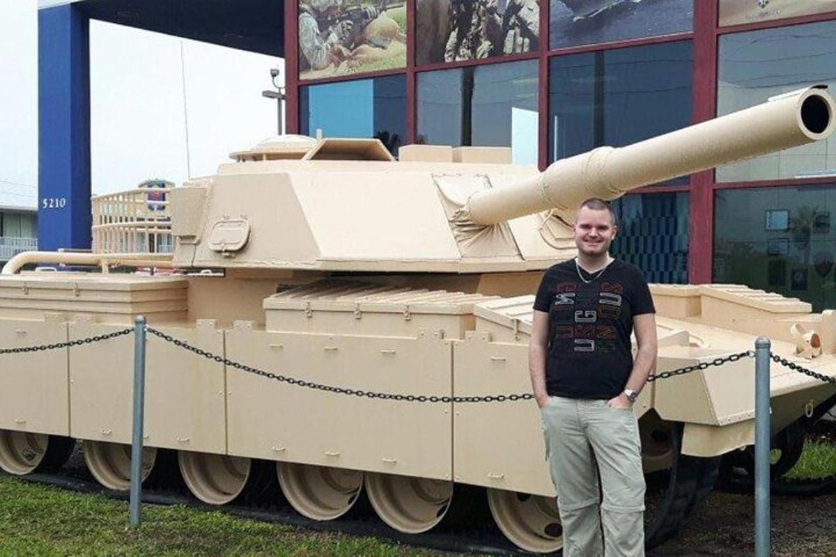 a man standing in front of a tank