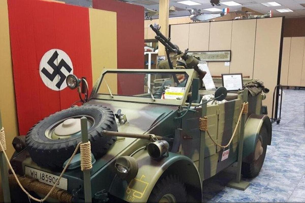 a military vehicle with a tire on the side of it