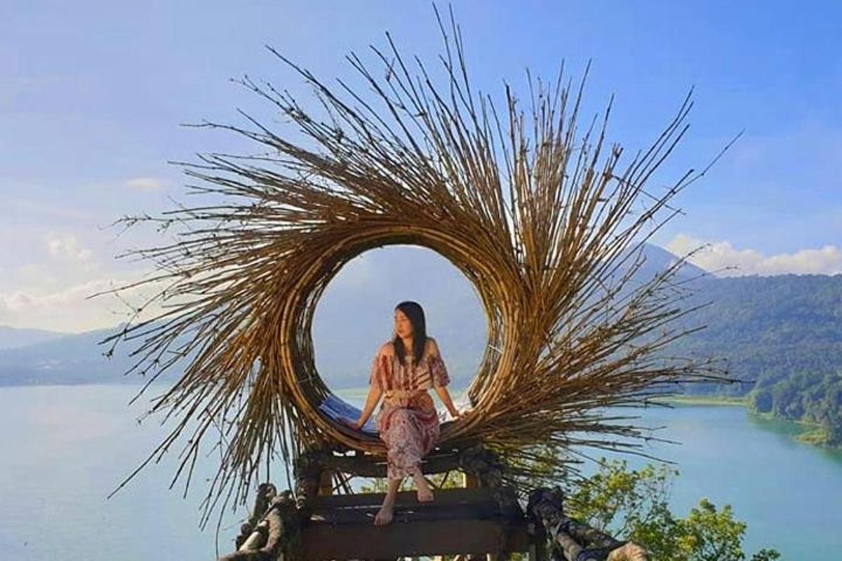o femeie stă într-o sculptură rotundă cu un lac