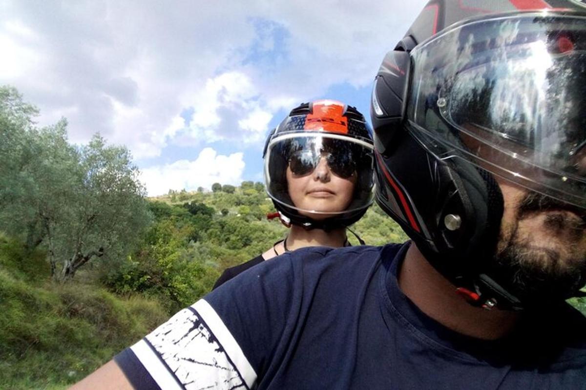 a man wearing a motorcycle helmet with a woman