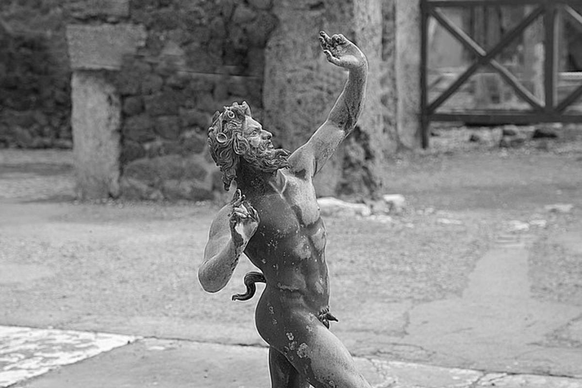 a statue of a woman standing in the mud