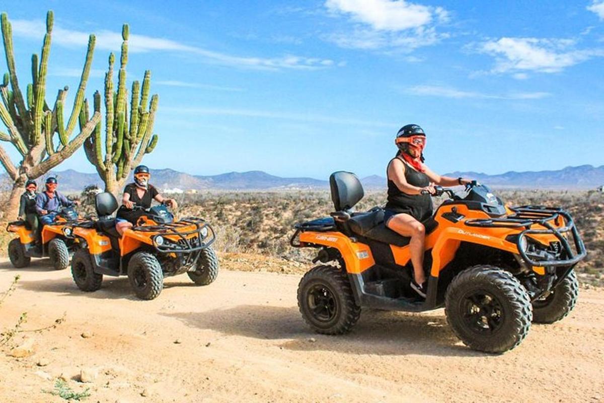 a group of people riding atvs on a dirt road