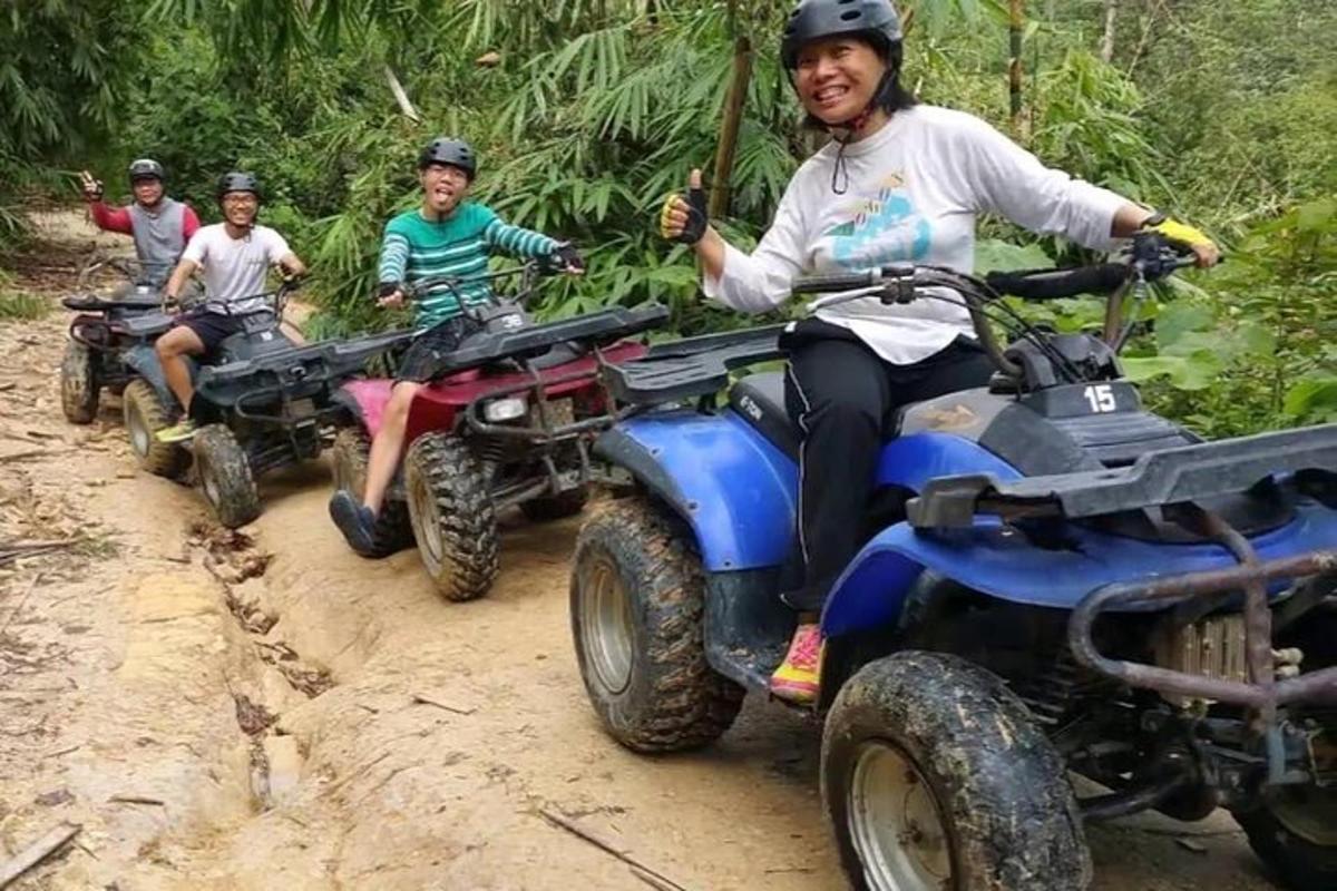 a group of people riding on atvs on a dirt road