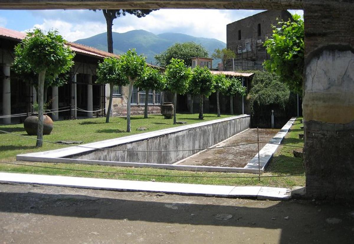 a building with a fountain in the middle of a street