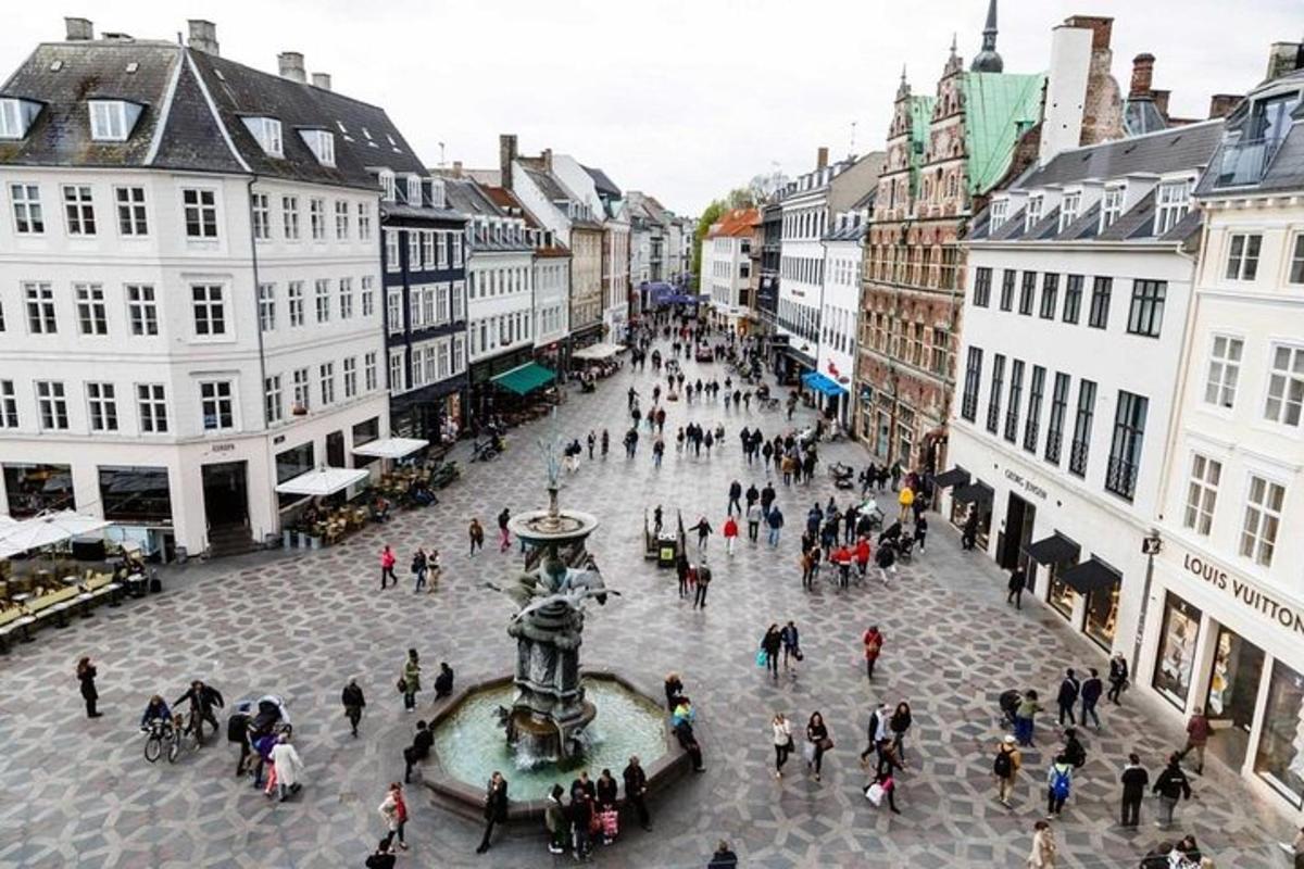 a group of people walking around a city street