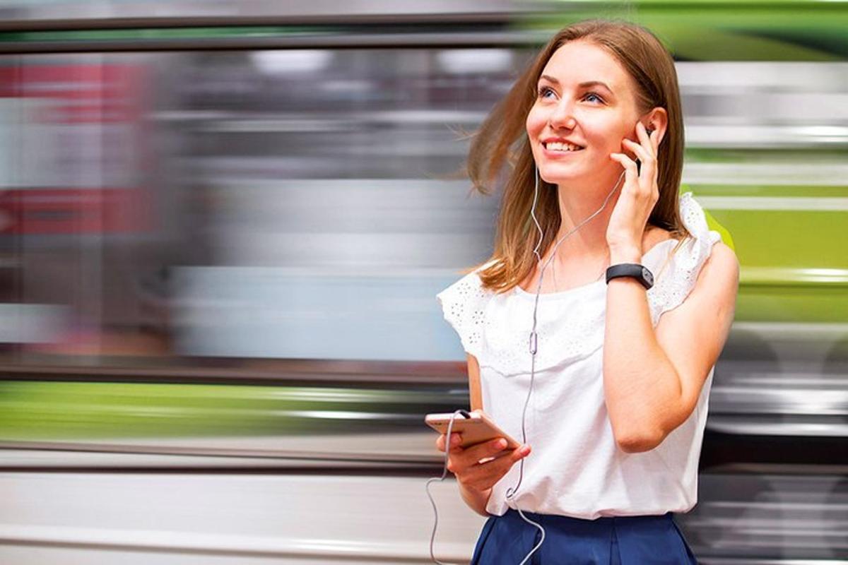 a woman talking on a cell phone with a train
