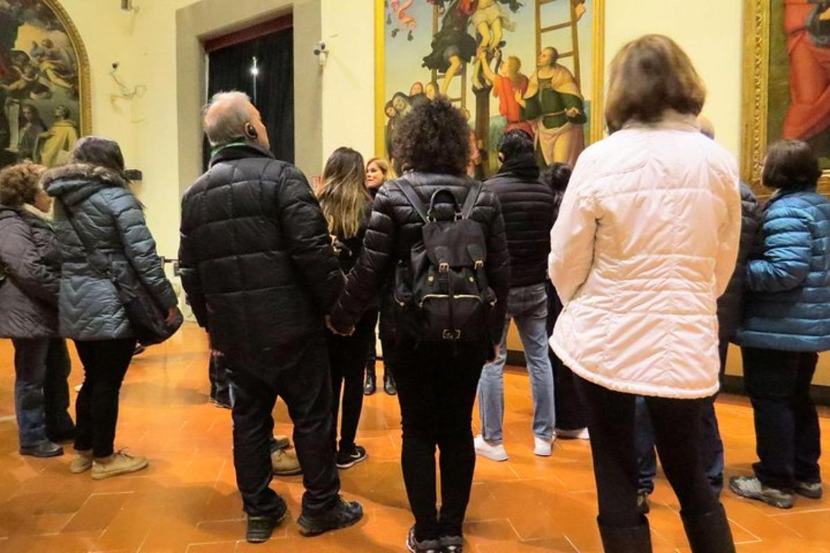 a group of people standing in a museum looking at art