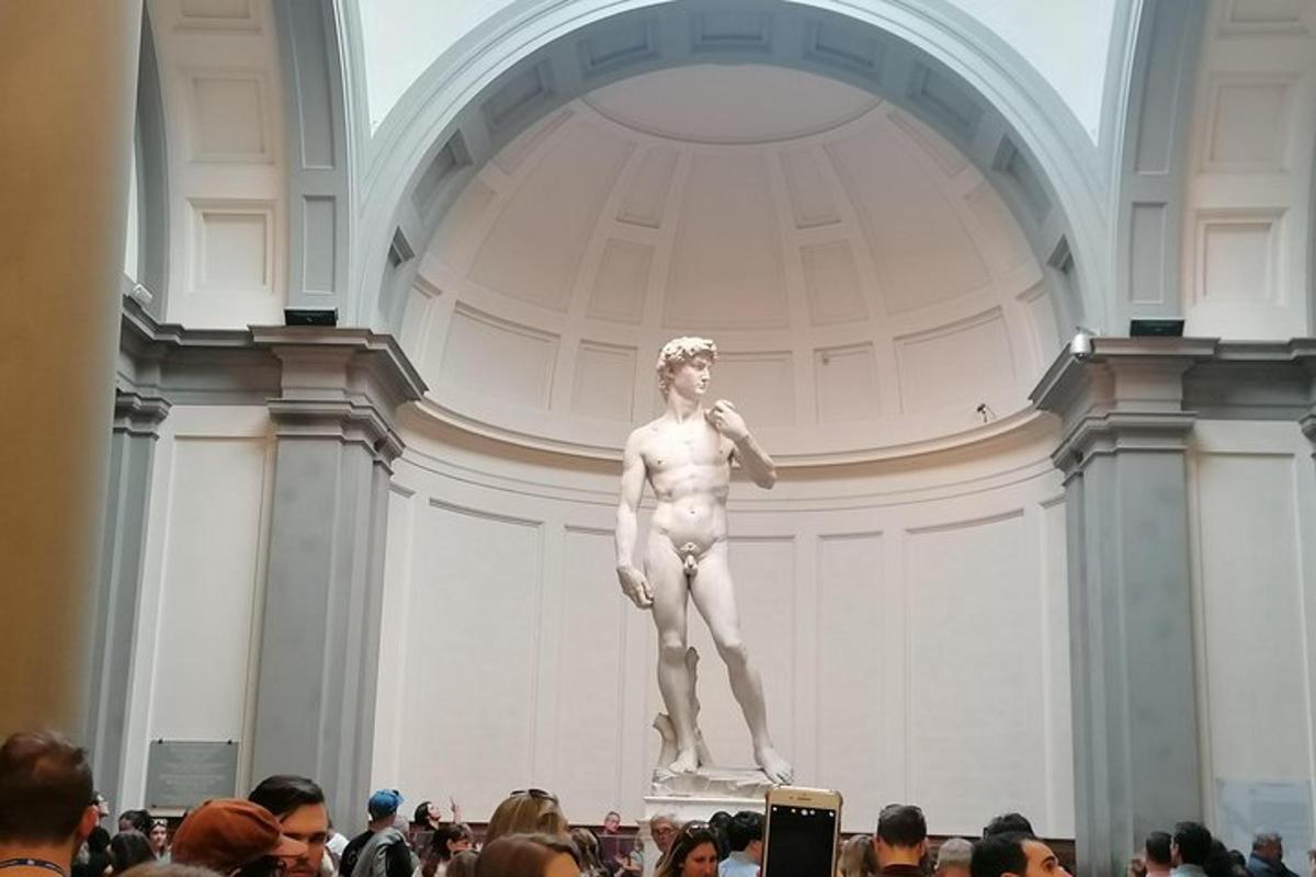 a statue of a man in a room with a crowd