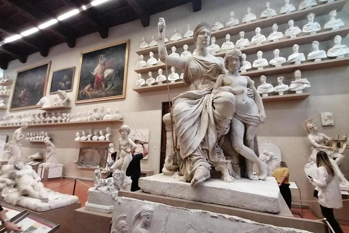 a group of people standing around a statue in a museum