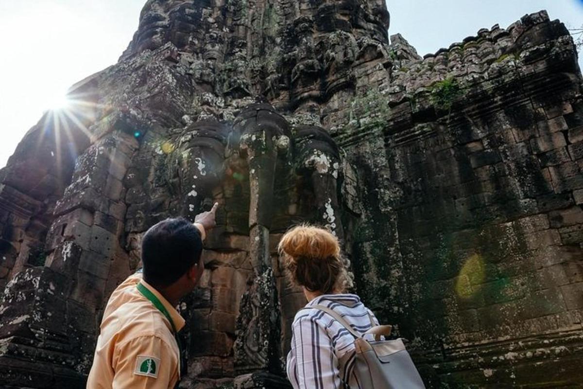 a man and a woman looking at a stone structure