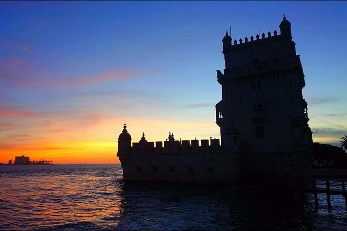 un castello sull'acqua con un tramonto sullo sfondo