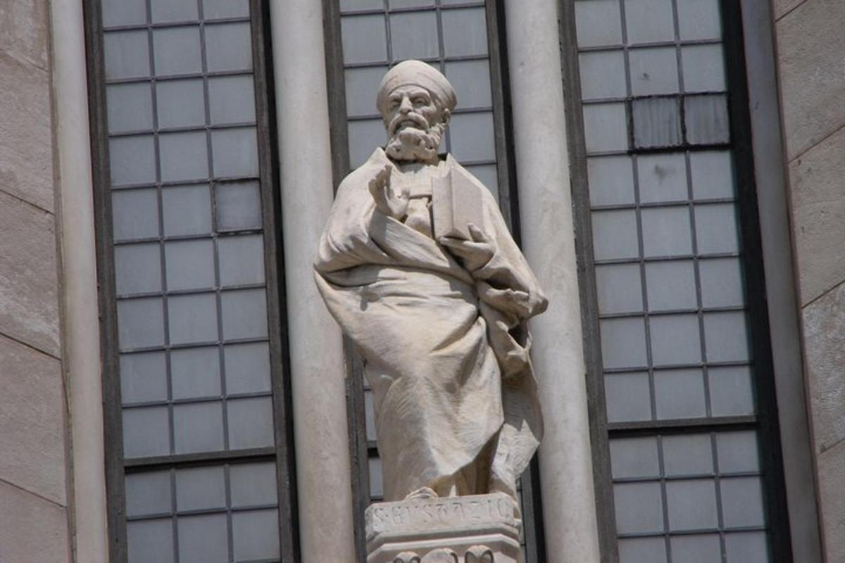 a statue of a man on the side of a building