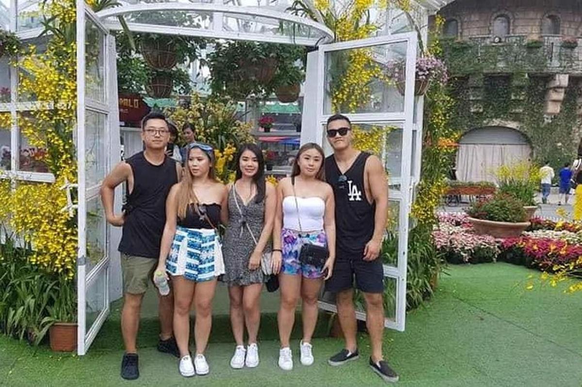 un grup de persones posant per a una foto en un jardí