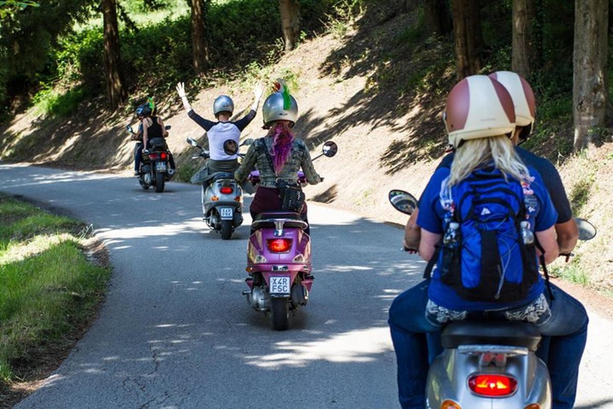 a group of people riding motorcycles down a road