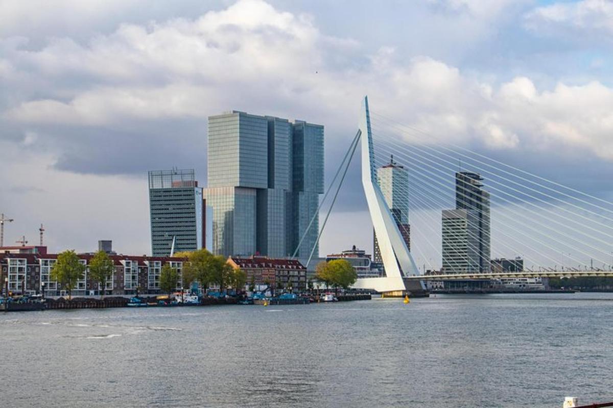 a bridge over a river in a city with tall buildings