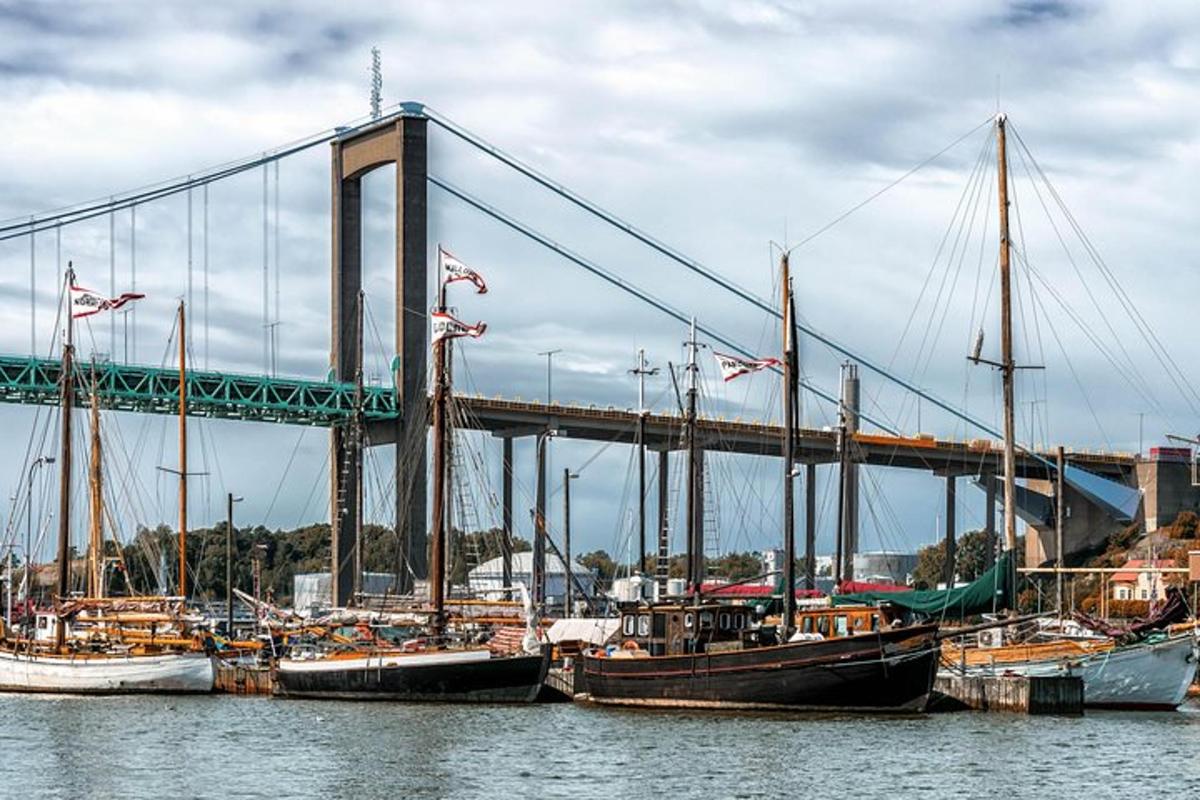 a group of boats docked in front of a bridge