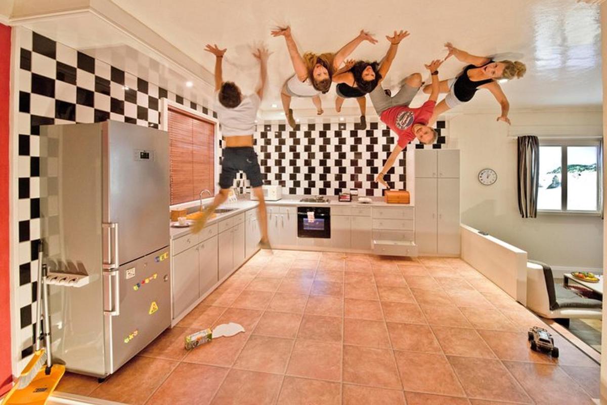 a group of people jumping in a kitchen