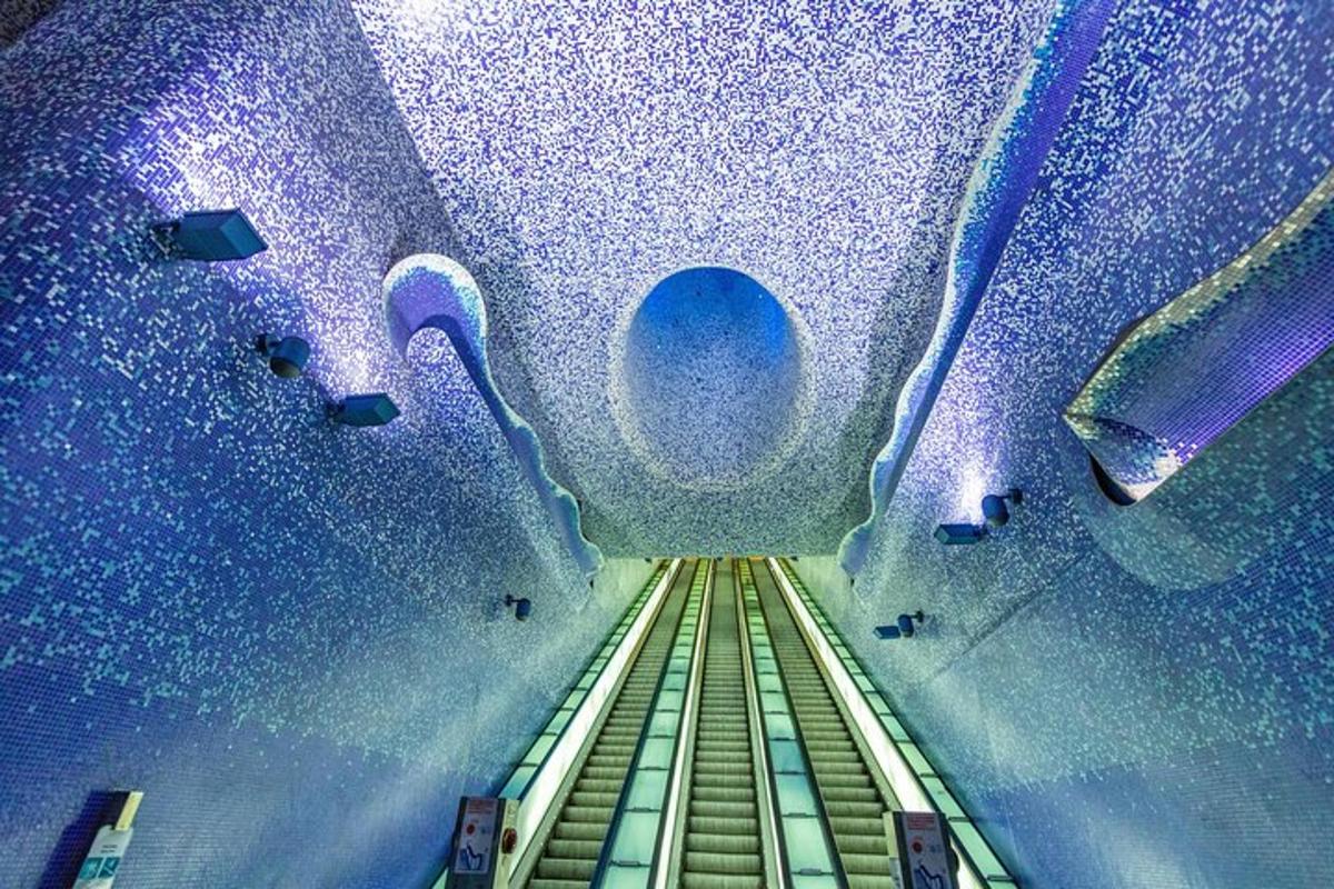 an escalator in a room with a blue ceiling