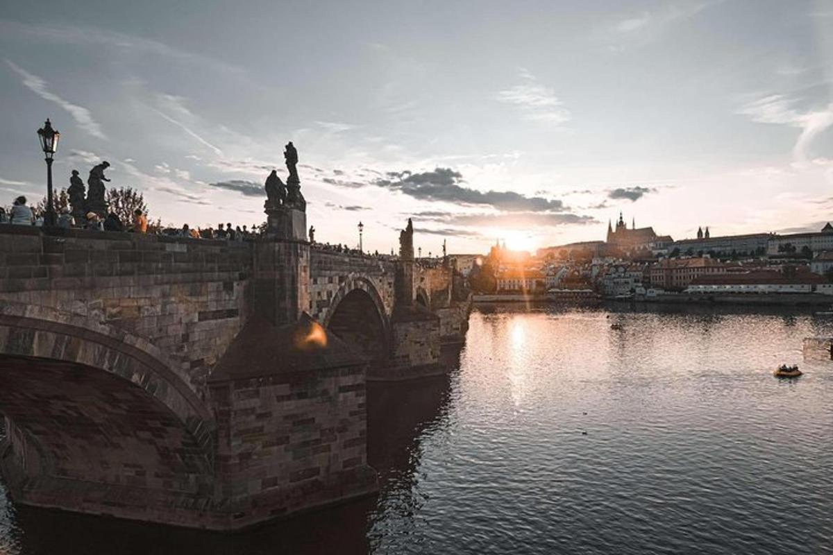 a bridge over a body of water with the sunset