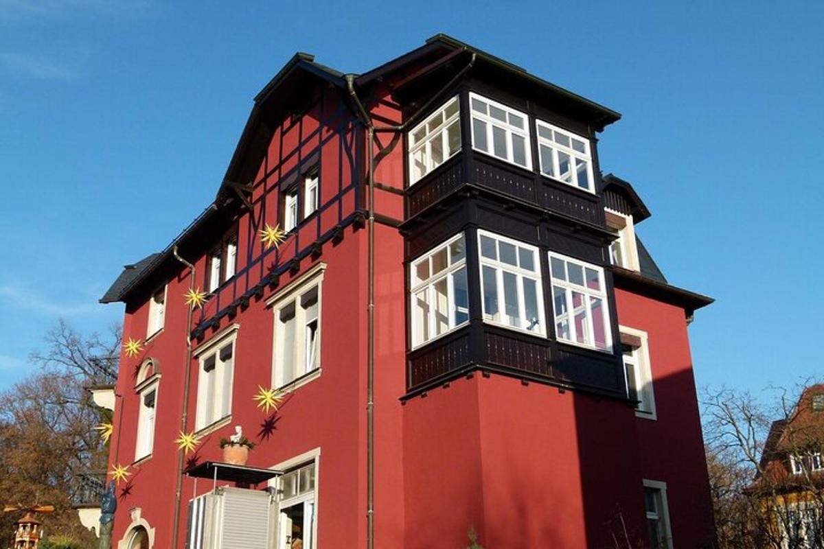 a red building with white windows on top of it