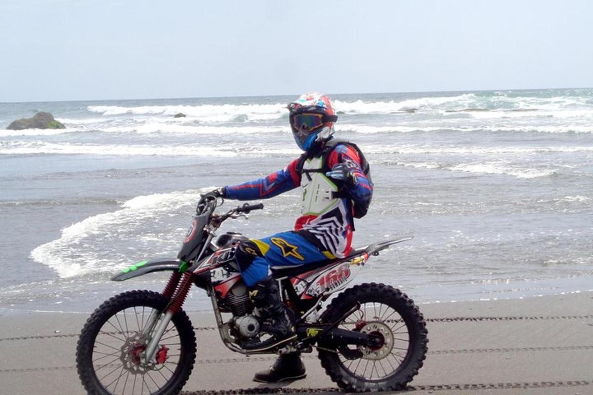 a person riding a dirt bike on the beach
