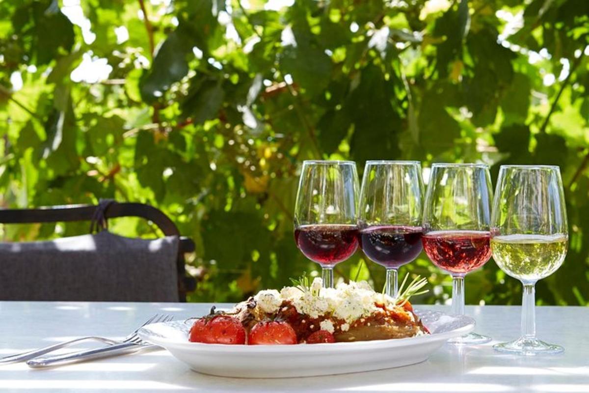 a table with a plate of food and wine glasses