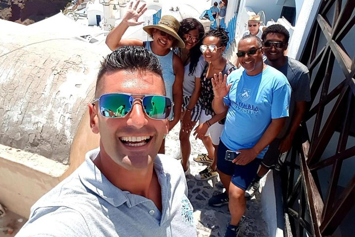 un gruppo di persone in piedi attorno a un uomo che indossa occhiali da sole