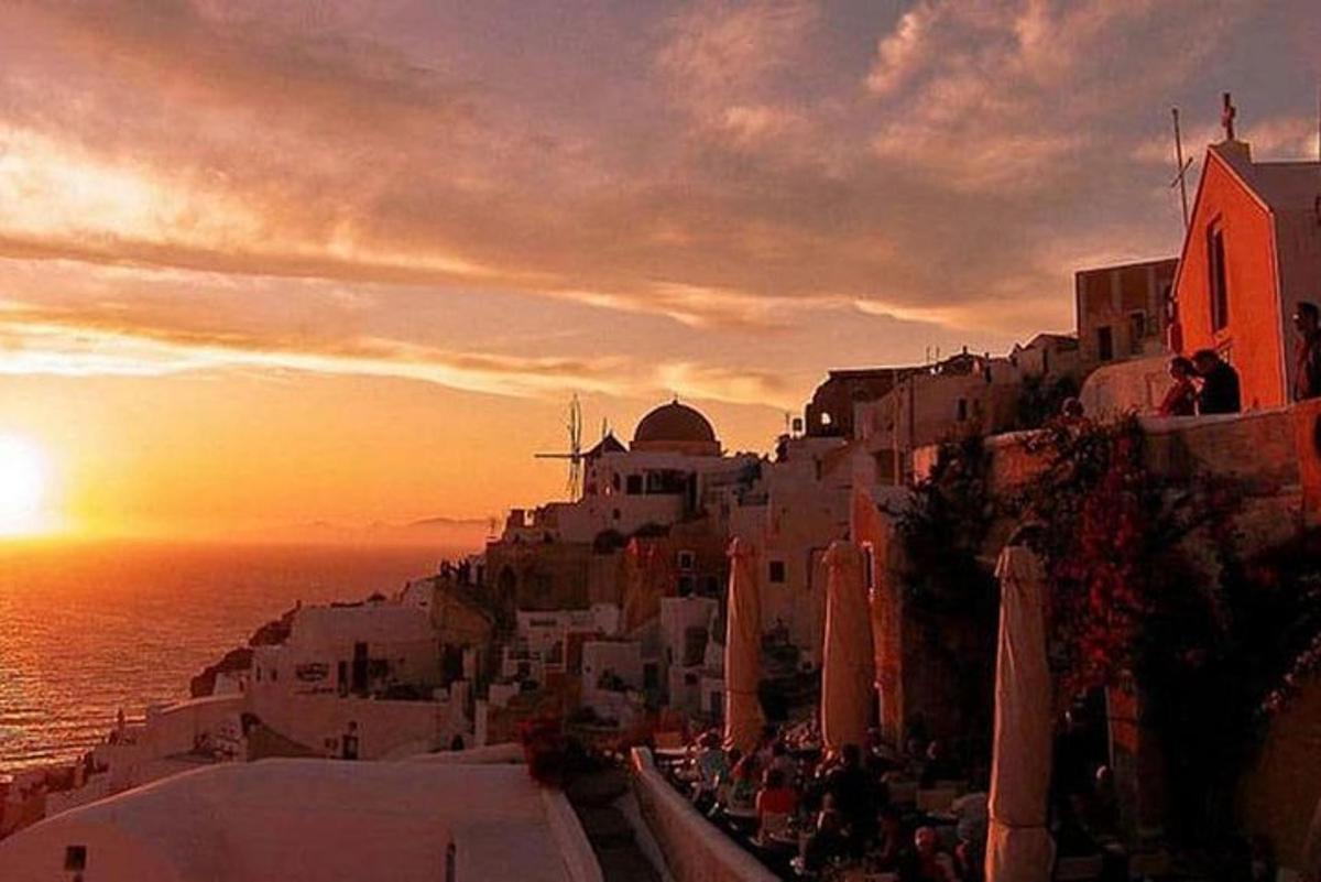 a sunset on the side of a hill with the ocean