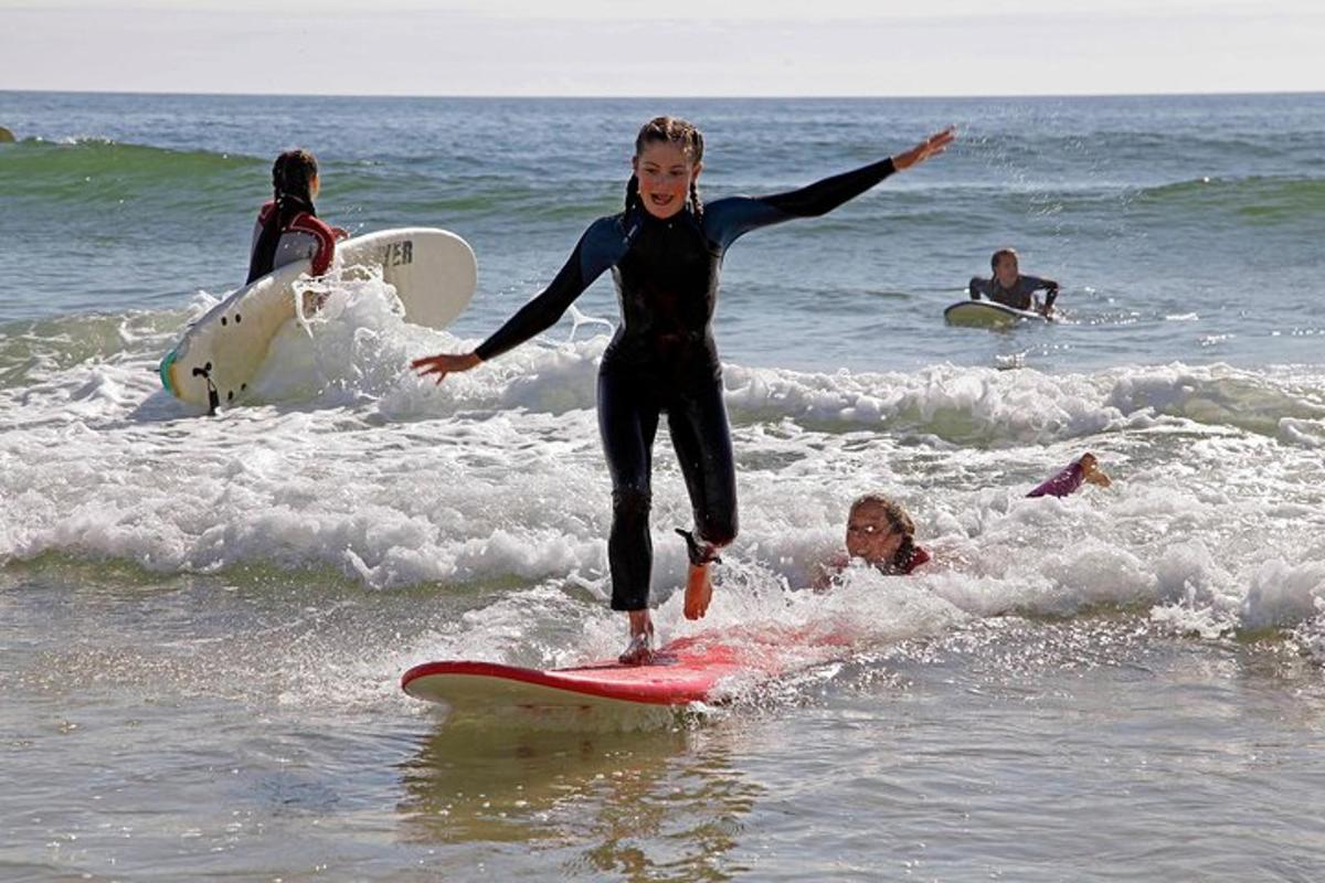a woman riding a wave on a surfboard in the ocean