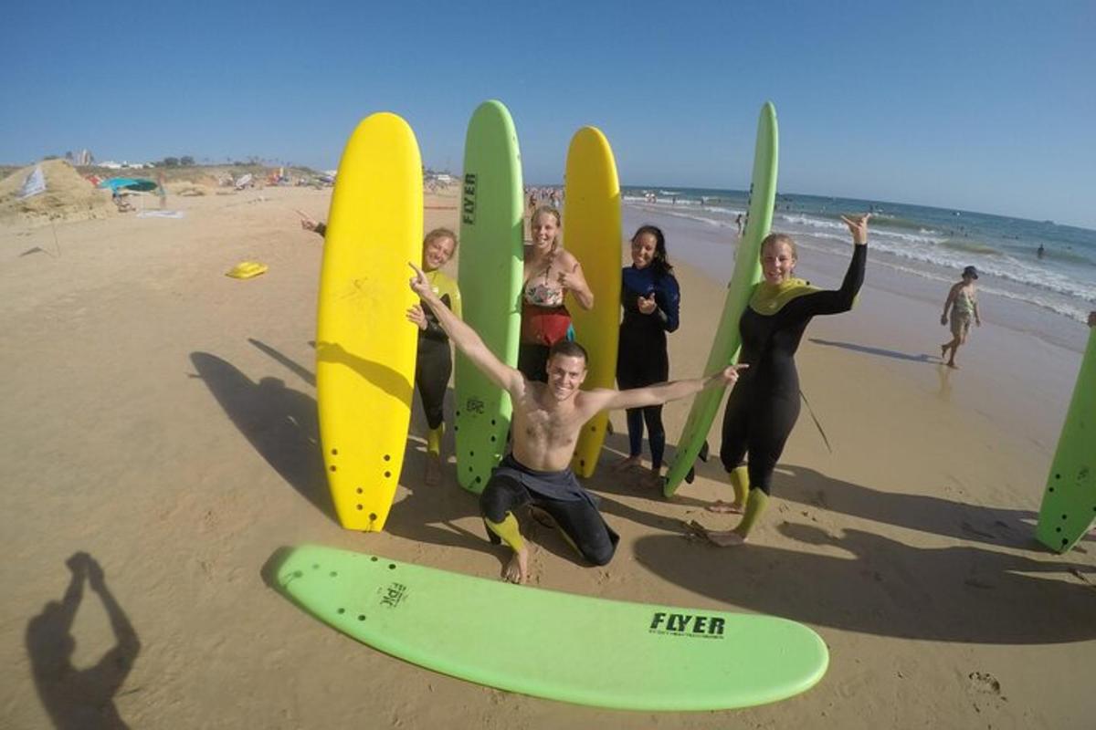 a group of people standing on the beach with surfboards