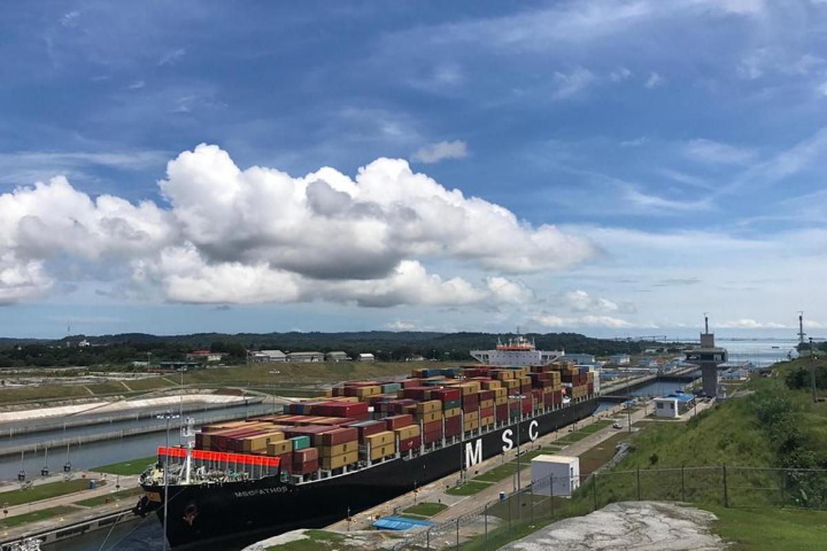 um grande navio porta-contêineres está atracado em um rio