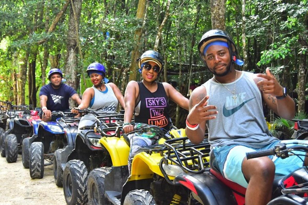 a group of people riding atvs down a dirt road