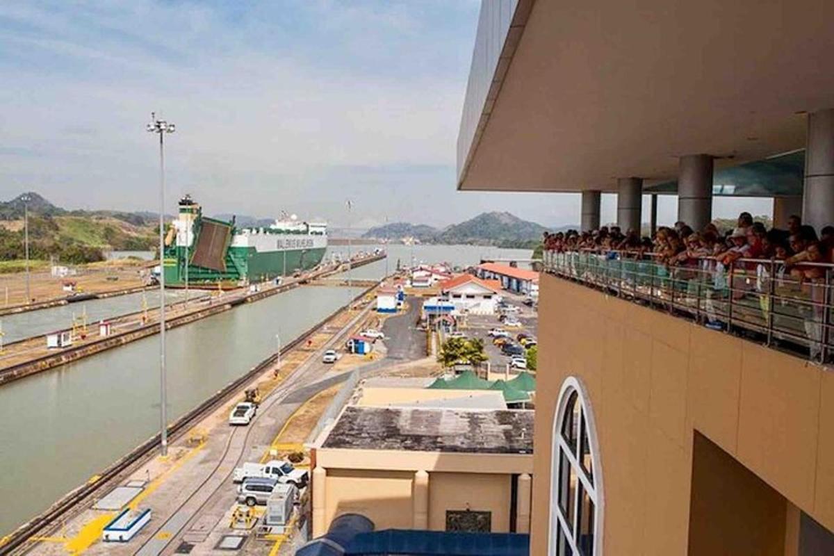 a crowd of people sitting on a balcony watching a bridge