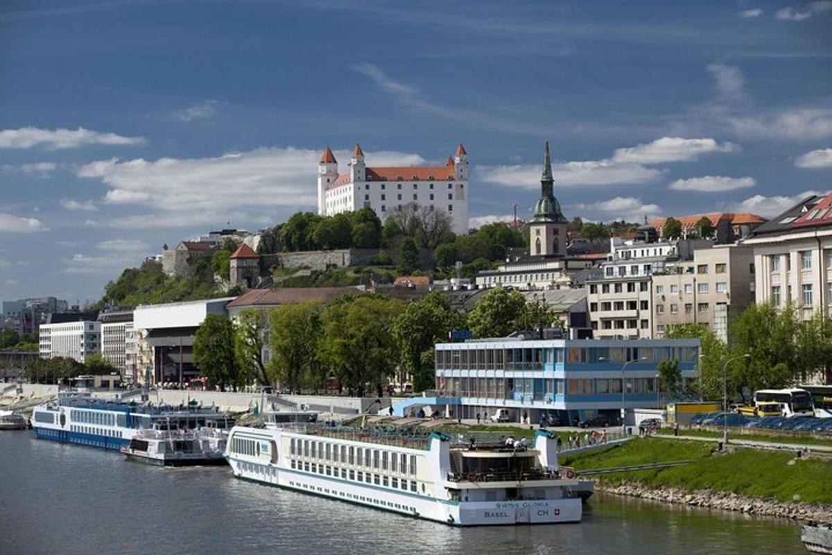 a large white boat in a river in a city