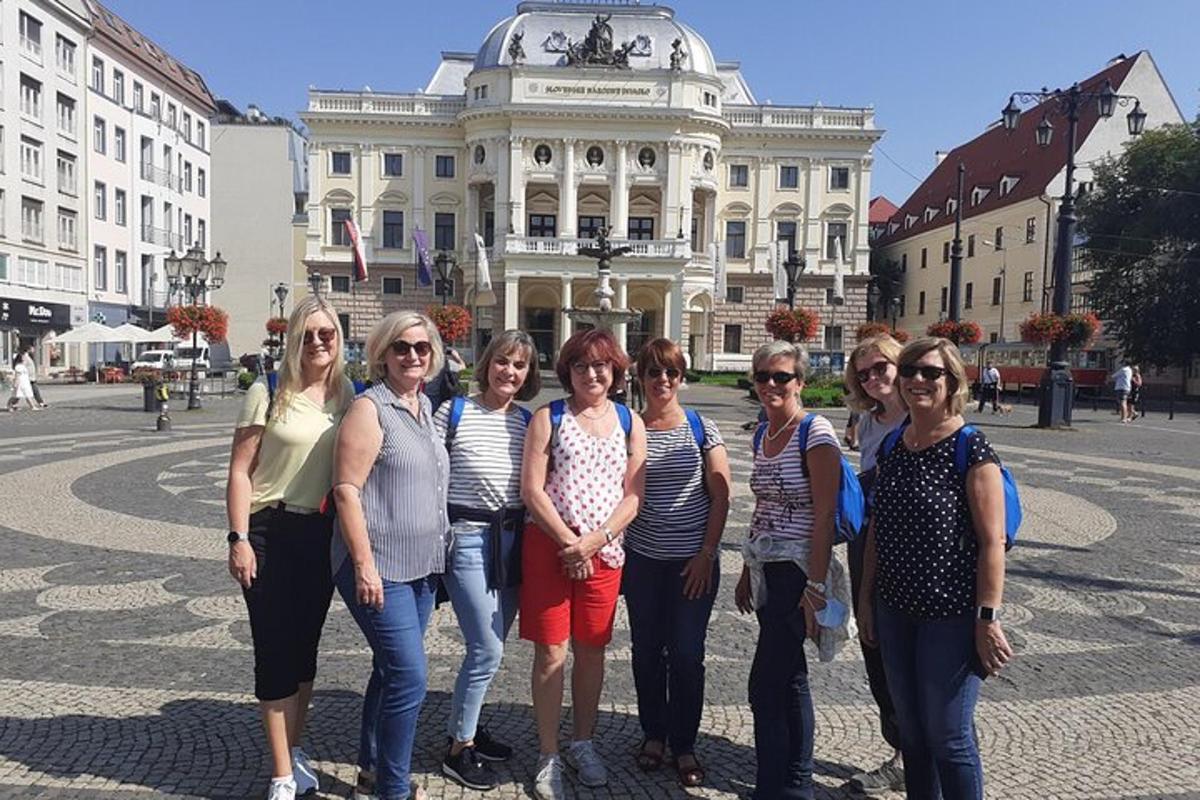 a group of women standing in front of a building
