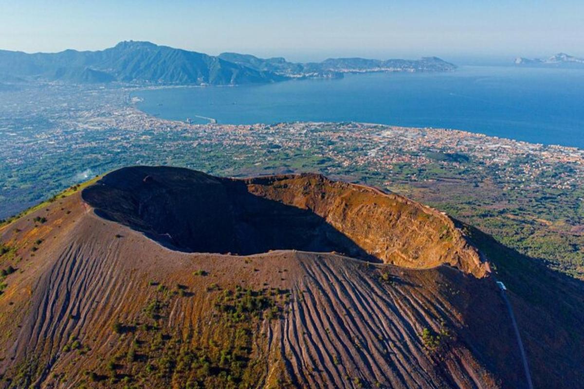an aerial view of a mountain with a city and water