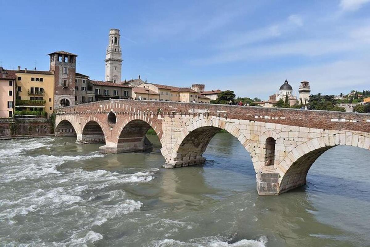 a stone bridge over a river in a city