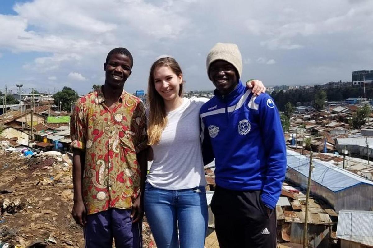 a woman and two men standing on top of a city