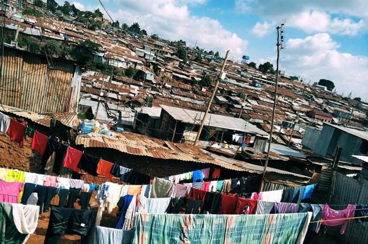 a group of houses on a hill with drying clothes