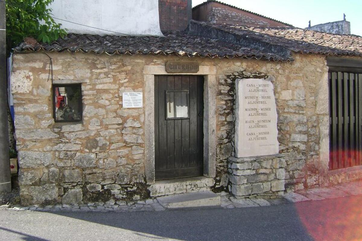 un vecchio edificio in pietra con una porta e un cartello