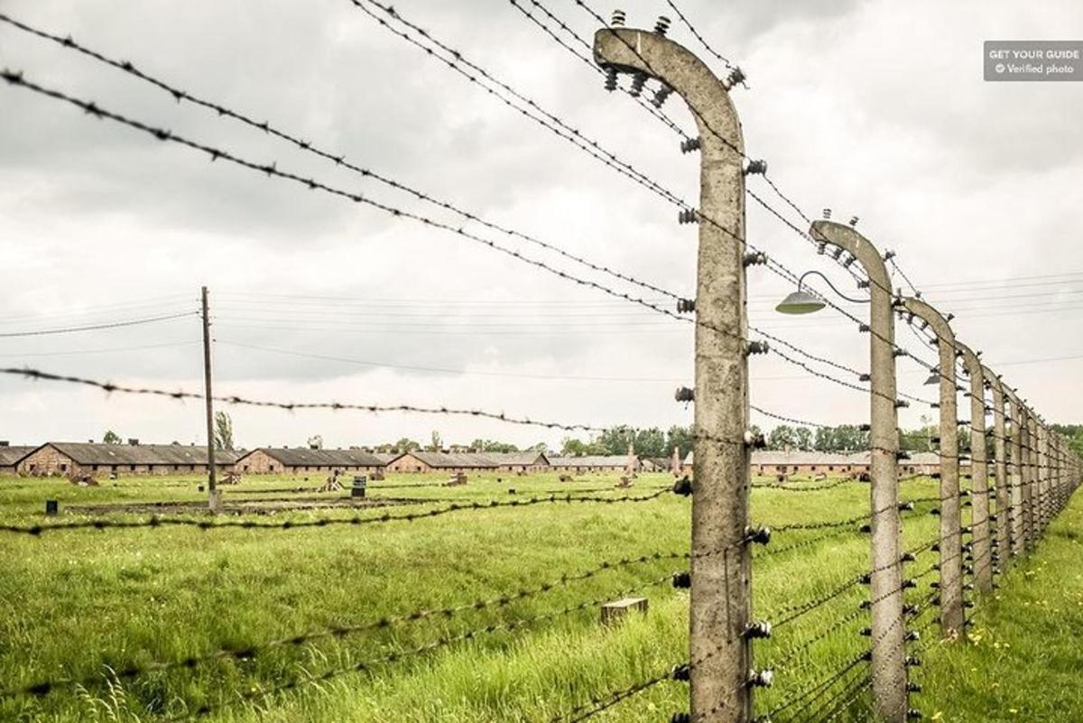 a fence with barbed wire and a pole