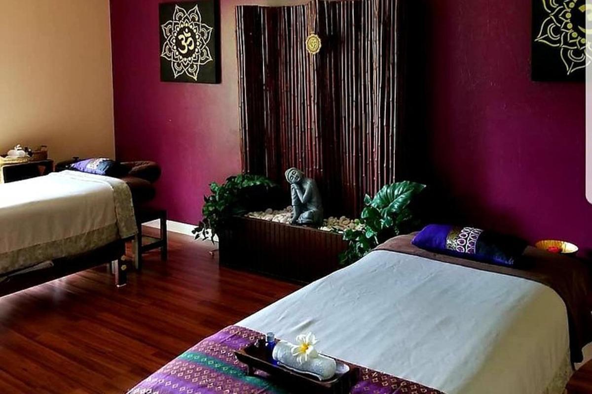 a bedroom with two beds and purple walls