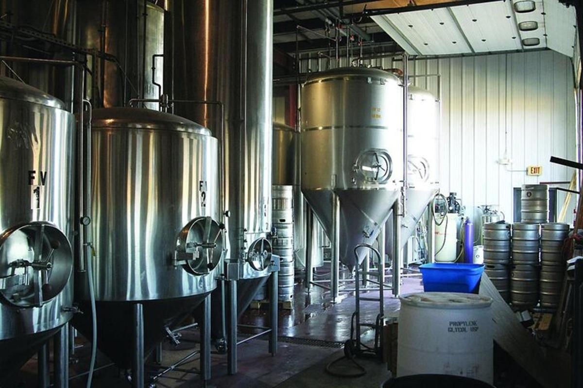a brewery with a bunch of silver tanks