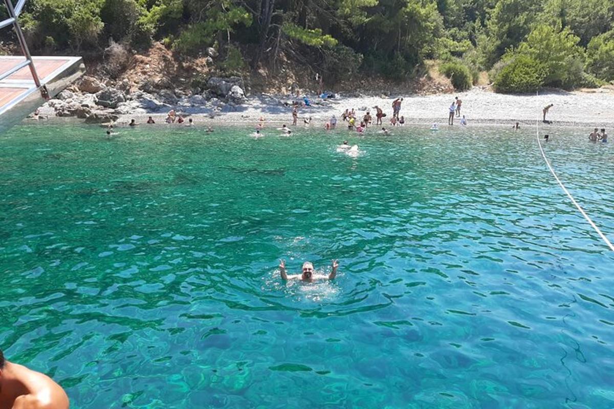 a group of people in the water at a beach