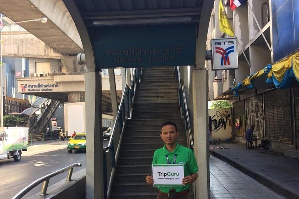 un home sosté un cartell davant d'un edifici