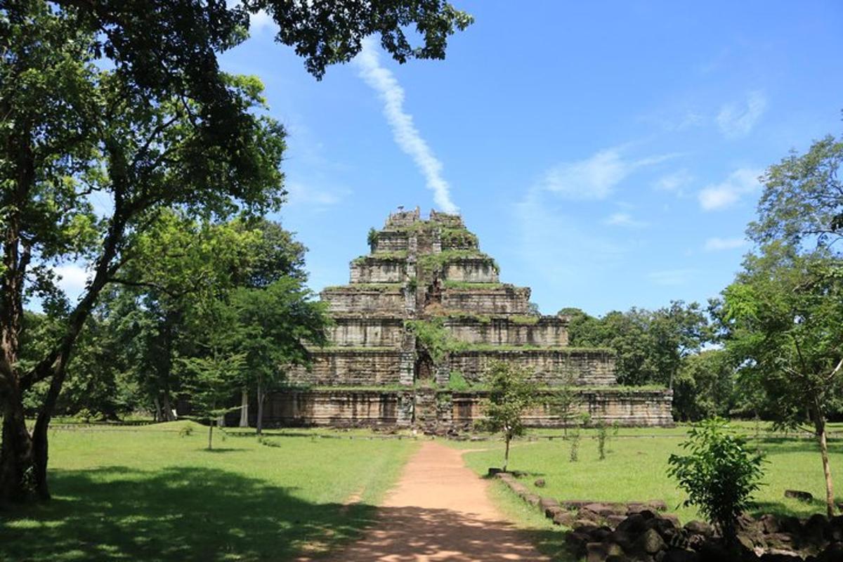 a large building in a field with a tree