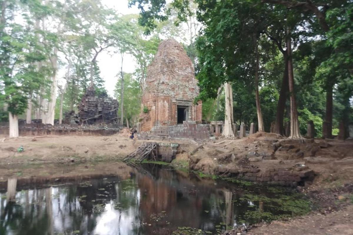 an old stone building next to a body of water