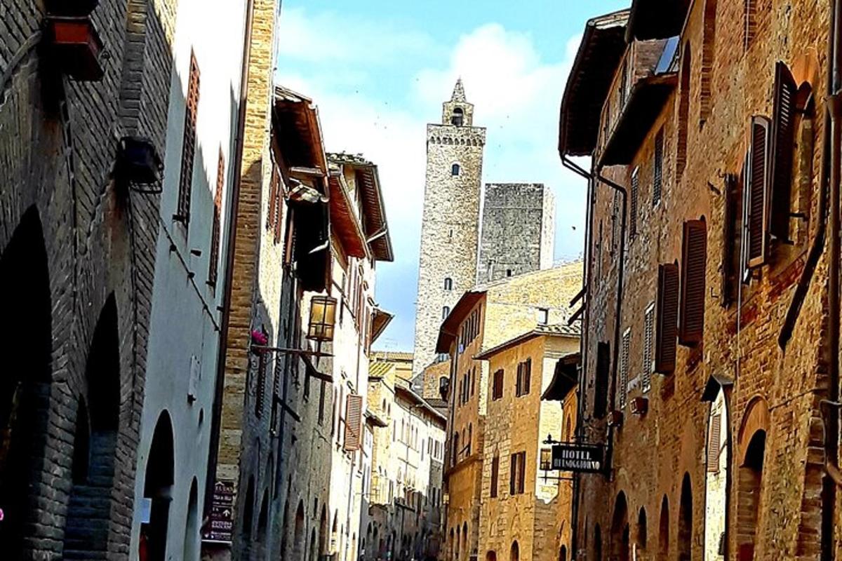un vicolo con una torre dell'orologio in lontananza